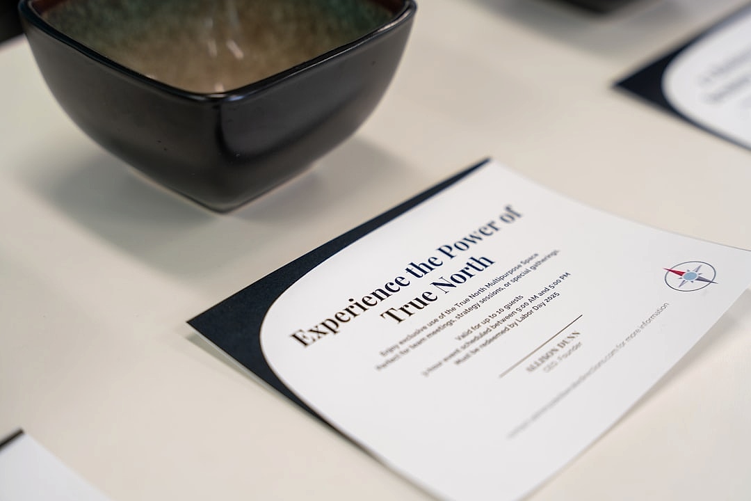 Professional workshop setting with participants focused on financial literacy materials